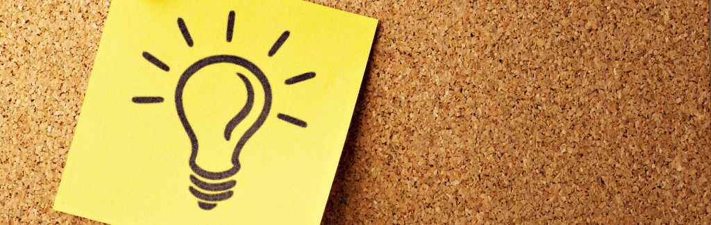 a yellow Post-It note with a sketch of a lightbulb