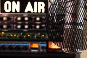 Photo of on air sign and radio studio mic
